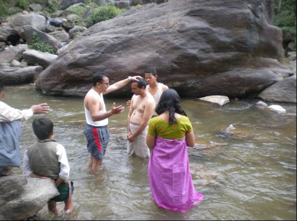 Ashok baptizing